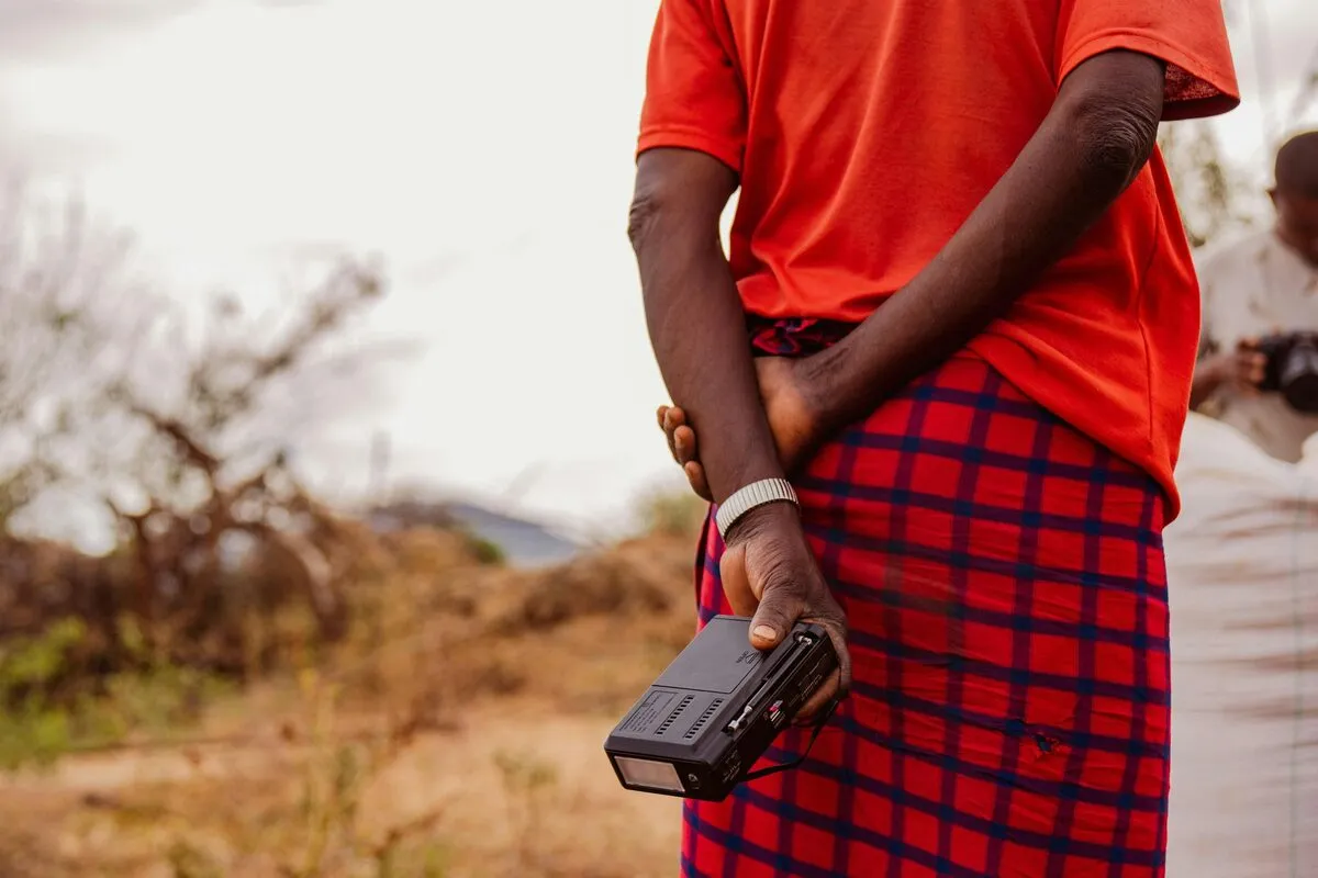 Field officer in a shuka holding a rugged data-collection device