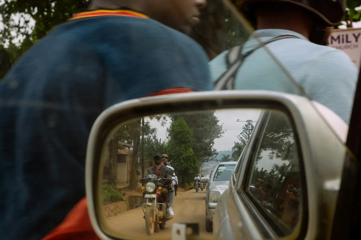 Street life seen in a car side mirror