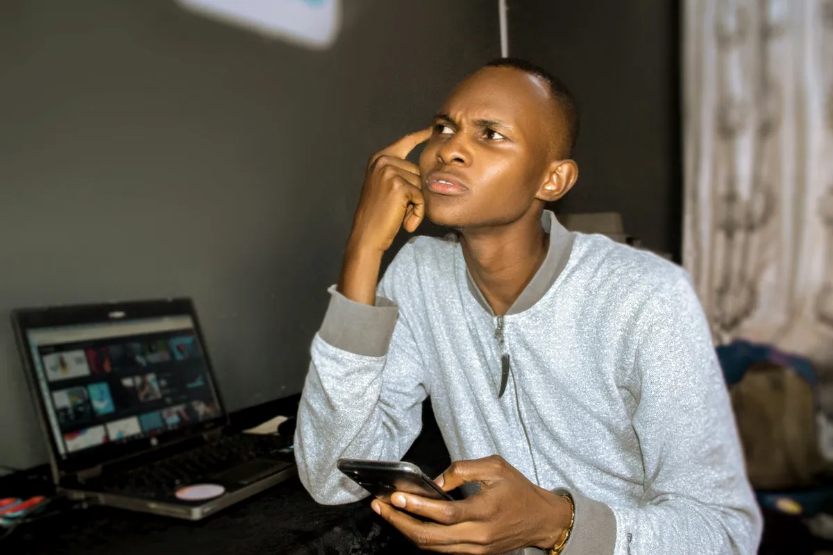 Business owner reviewing results on laptop and phone